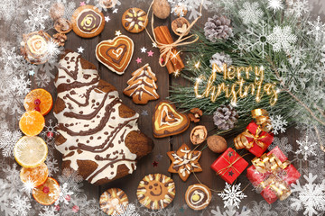 Christmas cookies with decorations on wooden background with merry christmas inscription