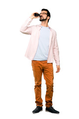 Handsome man with beard drinking beer