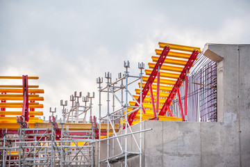 The supporting structure of scaffolding and metal beams on the construction of the bridge.