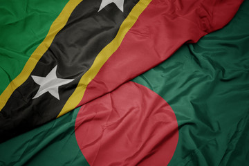 waving colorful flag of bangladesh and national flag of saint kitts and nevis.