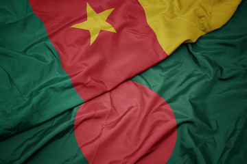 waving colorful flag of bangladesh and national flag of cameroon.