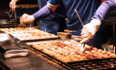 Process to Cooking Takoyaki on hot pan Famous Asian street food.