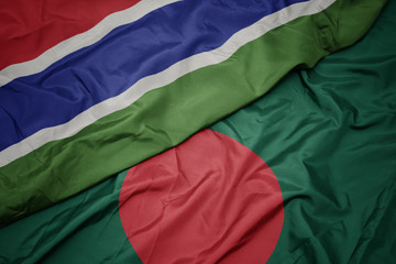 waving colorful flag of bangladesh and national flag of gambia.