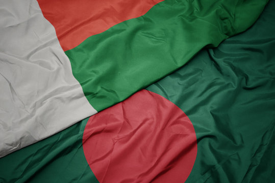 waving colorful flag of bangladesh and national flag of madagascar.