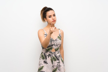 Young woman over isolated white background frustrated and pointing to the front