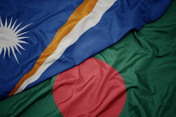 waving colorful flag of bangladesh and national flag of Marshall Islands .