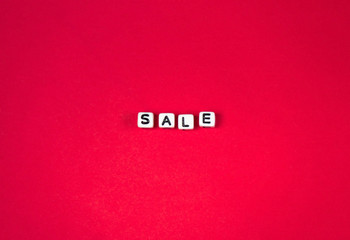 the word "sale" letters beads on a red background