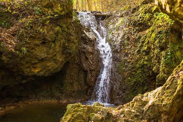 Smooth waterfall in the forest on mountain