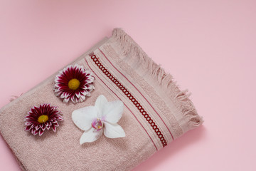 Soft terry towels with flowers on pink background.