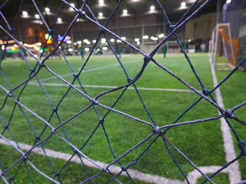 Blurred and selective focus of indoor soccer field on holiday at night time 