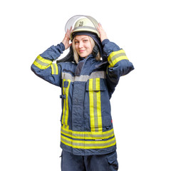 young smiling girl firefighter puts a helmet on his head. isolated on white background