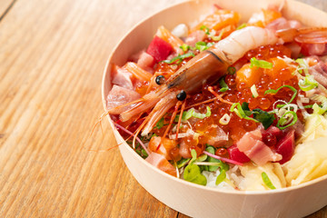 Tasty and delicious chirashi japanese food on wooden table background, Healthy Eating and Eat Well Concept. Take away home food. Close up