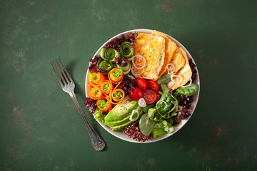 ketogenic paleo diet lunch bowl. halloumi cheese, avocado carrot cucumber salad leaves
