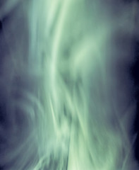 Obraz na płótnie Canvas Abstract green light smoke on a black background