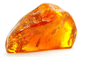 Beautiful transparent piece of amber on a white background. Natural mineral from fossilized ancient...