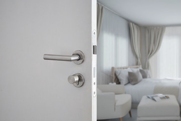 Door handle , door open in front of blur interior room background, selective focus