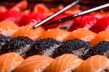 Various kinds of sushi served on a dark background