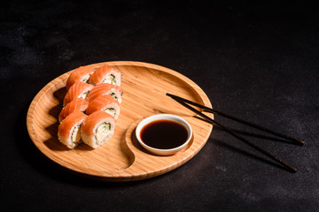 Various kinds of sushi served on a dark background