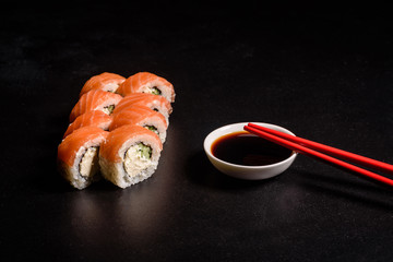 Various kinds of sushi served on a dark background