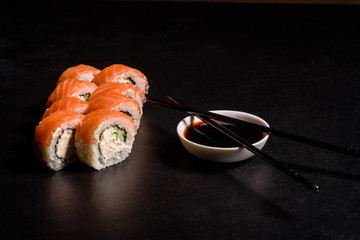 Various kinds of sushi served on a dark background