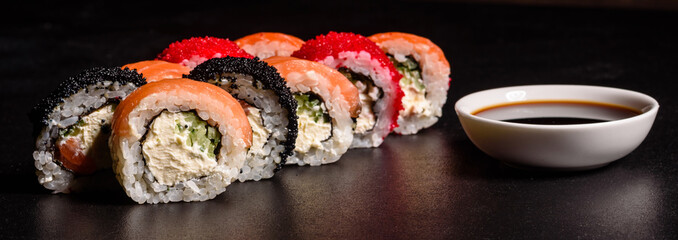 Various kinds of sushi served on a dark background