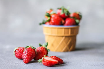 Photo of heap of fresh strawberries in the bowl on rustic grey background..A bunch of ripe strawberries in a bowl on the table. Copy space. Healthy fresh fruit. Organic food. Clear food