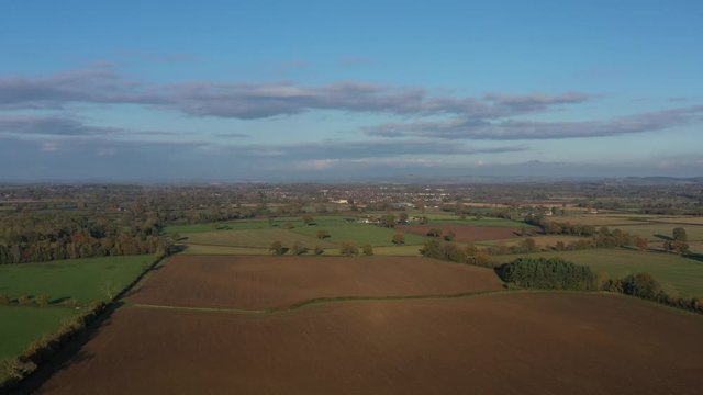 Wide profile aerial slider shot of Moreton-In-Marsh, autumnal landscape of the Cotswolds.