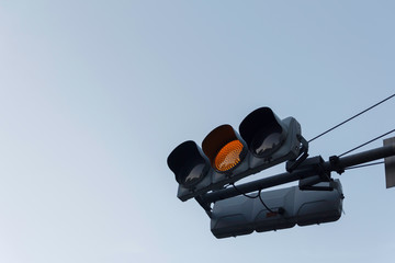 Yellow traffic light ,isolated on sky background