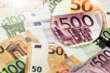 Magnifying Glass with Euro Banknotes