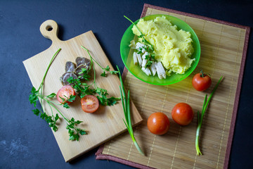boiled potatoes with chop and fresh tomatoes, top view
