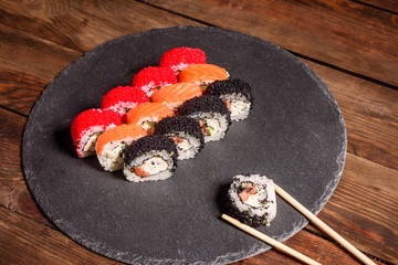 Various kinds of sushi served on a dark background