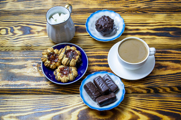 coffee with milk with cookies on a wooden background, top view