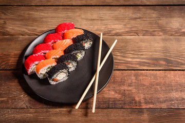 Various kinds of sushi served on a dark background