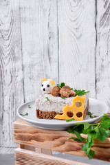 Salty cheesecake garnished with roasted champignons. New Year 2020 appetizer with the mouse of quail eggs, symbol of the new year