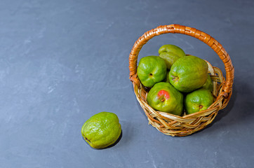 ugly quince chinese pear in a basket on a dark background with place for text