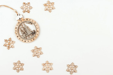 Wooden snowflakes and Christmas plywood toy on a white background copy space