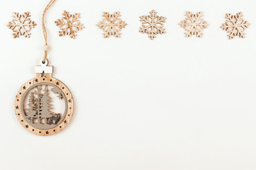 Wooden snowflakes and Christmas plywood toy on a white background copy space