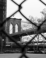 brooklyn bridge seen through the fence