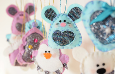 Various Christmas decorations hanging on ribbon