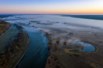 Sunny and foggy morning over the river, fog in the sun.