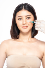 Asain young woman gets injection of botox in her lips. Woman in beauty salon. plastic surgery clinic.Beautiful woman gets botox injection in her face.