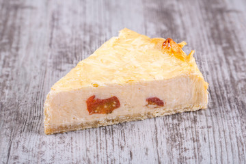 Piece of pie with slugged tomatoes and basil from chopped dough