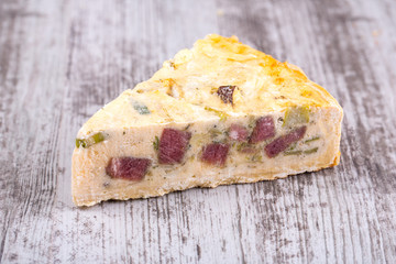 Piece of pie with onion poree and beef smoked