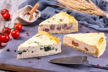 Pies in range on wooden board with cherry tomatoes