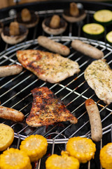grill with potatoes, turkey meat, zucchini, mushrooms and sausages