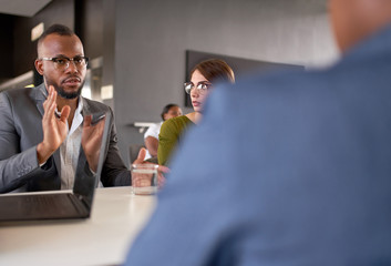 Unposed shot of male African American businessperson explaining