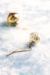 Christmas golden baubles on bright wooden background. Close up. Copy space. 