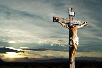 A small statue of Jesus Christ on the Cross - obrazy, fototapety, plakaty