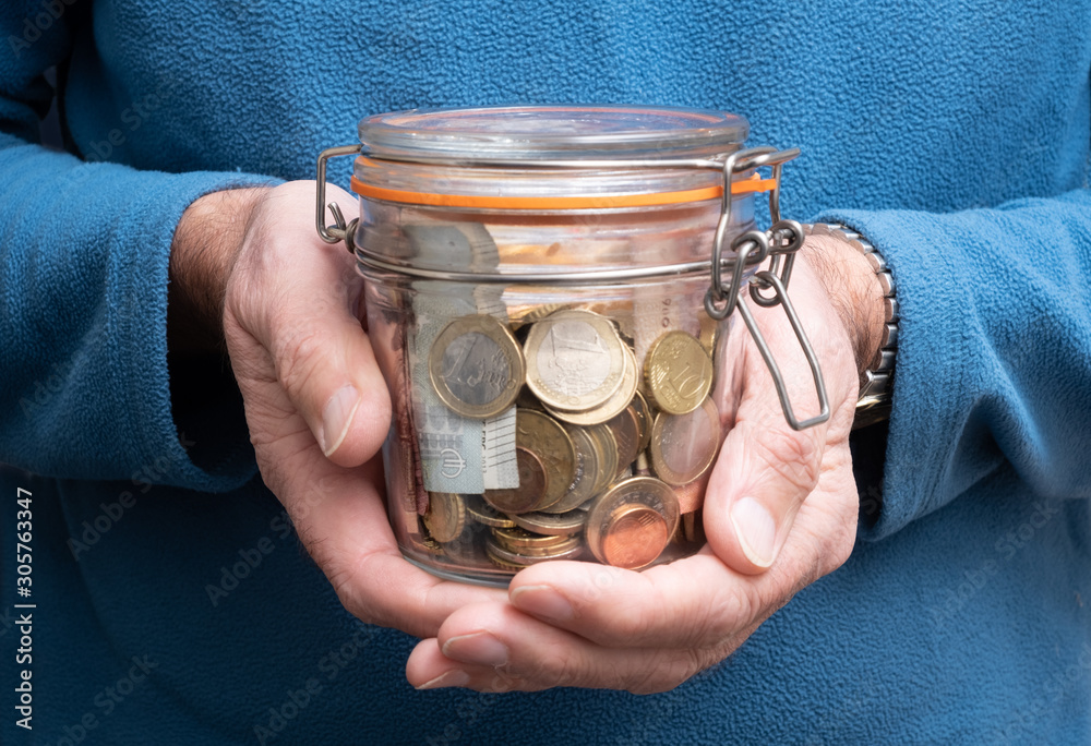 Wall mural man hands holding jar full of euro money, pension fund concept, coins and banknotes