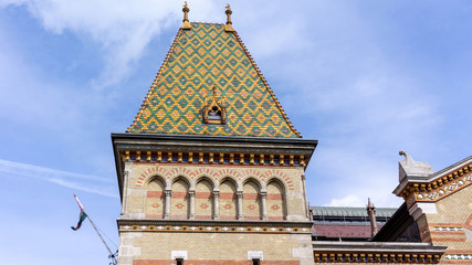 Great Market Hall, Budapest. The building was designed and built by Samu Pecz in 1897. A distinctive architectural feature is the roof which was restored to have colorful Zsolnay tiling from Pécs.